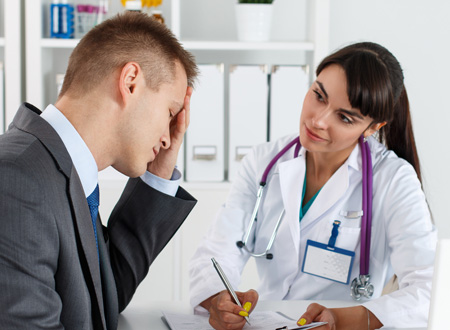 distraught man speaking with female doctor