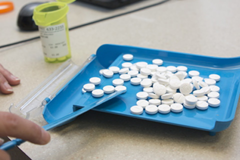 prescription medication being counted for bottling