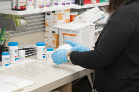 attendant preparing prescription